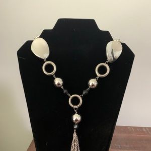 Long silver necklace with beads and charms